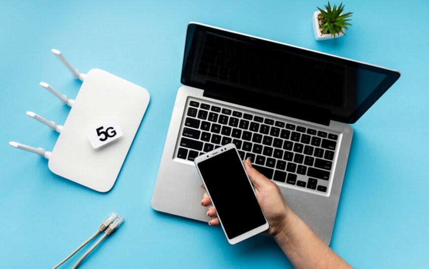 router laptop and a hand holding mobile